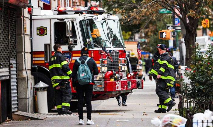 Firefighters watch as their fire engine enters the FDNY Engine 281/Ladder 147 station in the Flatbush neighborhood of Brooklyn borough in New York City on Oct. 29, 2021. (Michael M. Santiago/Getty Images)