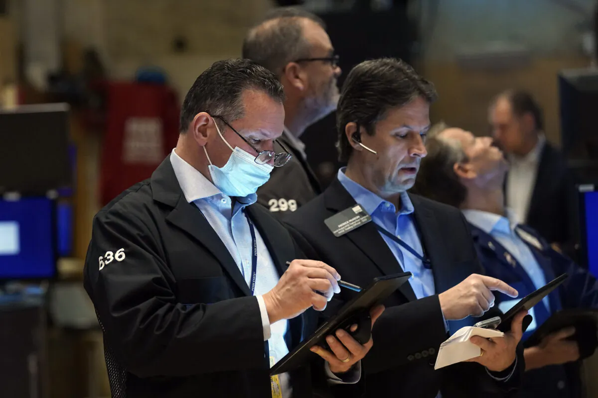 Edward Curran (L) works with fellow traders on the floor of the New York Stock Exchange on Nov. 2, 2021. (Richard Drew/AP Photo)