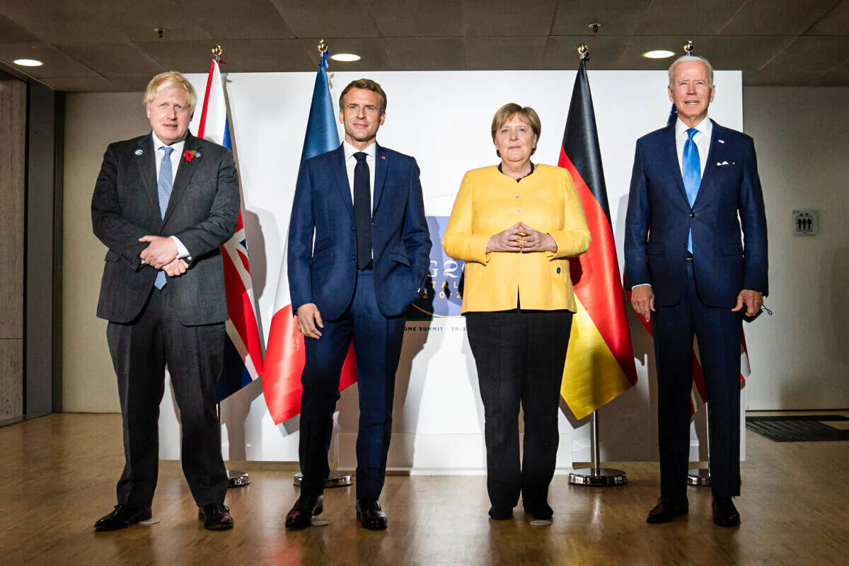 (L-R) British Prime Minister Boris Johnson, French President Emmanuel Macron, German Chancellor Angela Merkel, and U.S. President Joe Biden, pose for the media prior to a meeting at the La Nuvola conference center for the G20 summit in Rome, Italy, on Oct. 30, 2021. (Stefan Rousseau/Pool/Getty Images)