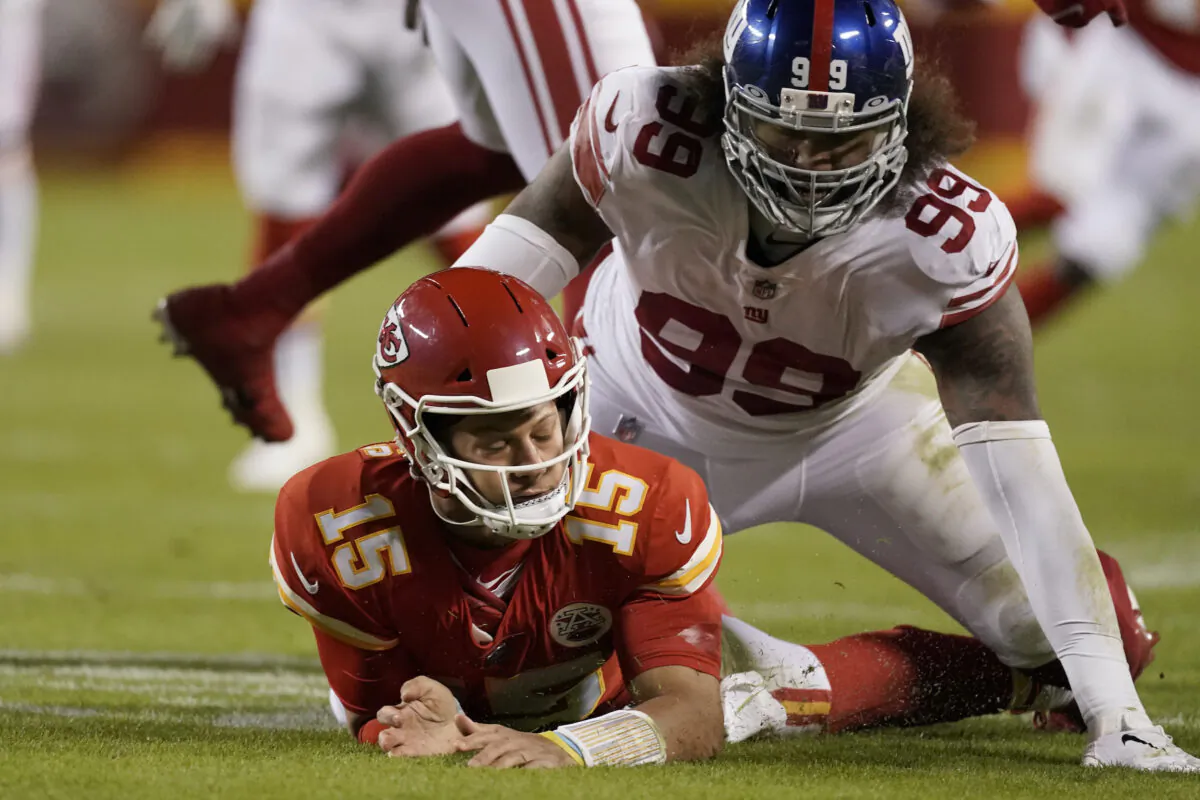 Kansas City Chiefs quarterback Patrick Mahomes (15) is slow to get up after throwing under pressure from New York Giants defensive end Leonard Williams (99) during the first half of an NFL football game in Kansas City, Mo., on Nov. 1, 2021. (Charlie Riedel/AP Photo)