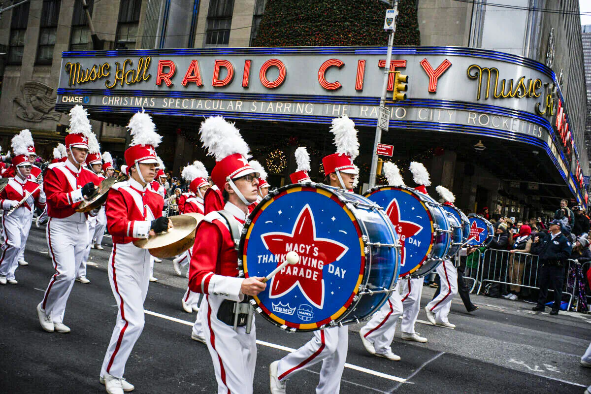 Revelers makes their way down the Avenue of the Americas in front of Radio City Music Hall during the Macy's Thanksgiving Day Parade in New York on Nov. 28, 2019. (Eduardo Munoz Alvarez/AP Photo)