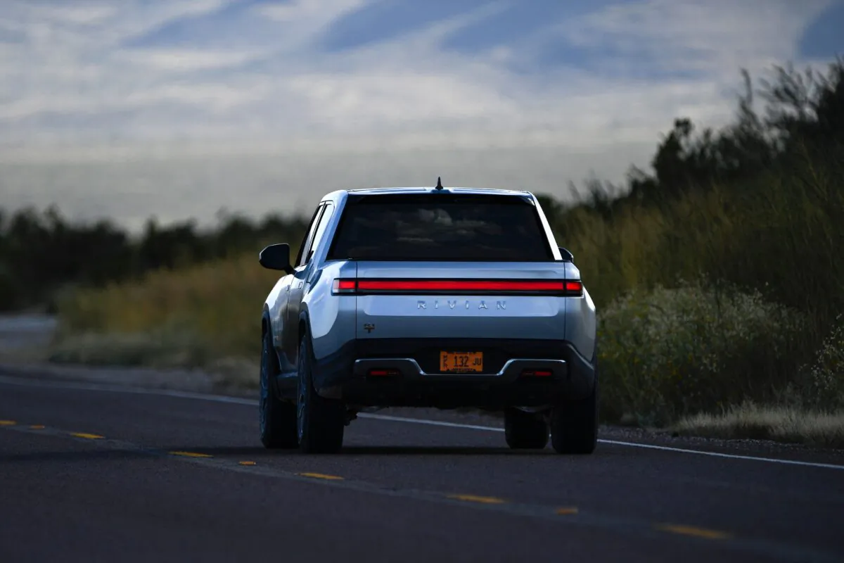 A Rivian R1T electric truck drives down a highway near the entrance to Blue Origin's Launch Site One outside of Van Horn, Texas, on Oct. 12, 2021. (Patrick T. Fallon/AFP via Getty Images)