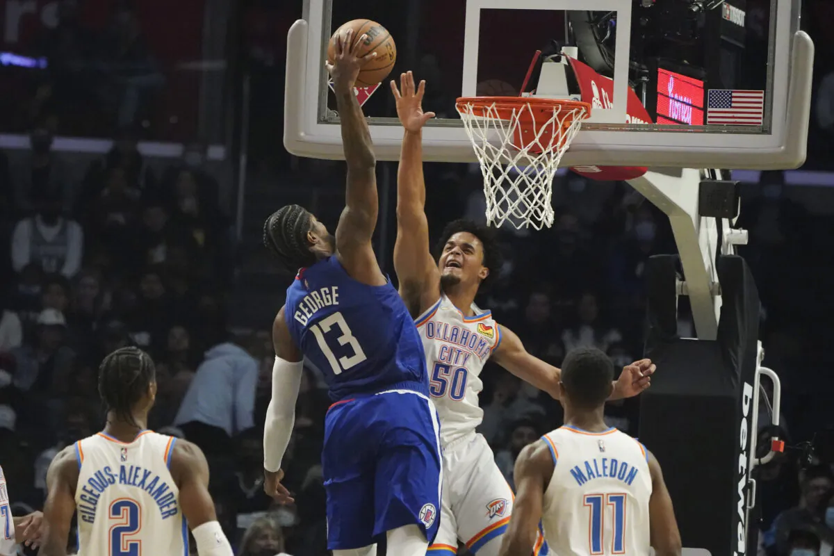 Los Angeles Clippers guard Paul George (13) makes a dunk attempt as Oklahoma City Thunder forward Jeremiah Robinson-Earl (50) defends during the first half of an NBA basketball game in Los Angeles on Nov. 1, 2021. (AP Photo/Marcio Jose Sanchez)