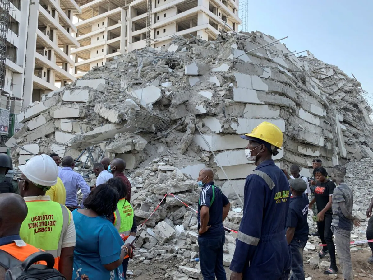 Emergency personnel stands by the debris of the collapsed building in Ikoyi, Lagos, Nigeria on Nov. 1, 2021. (Nneka Chile/Reuters)