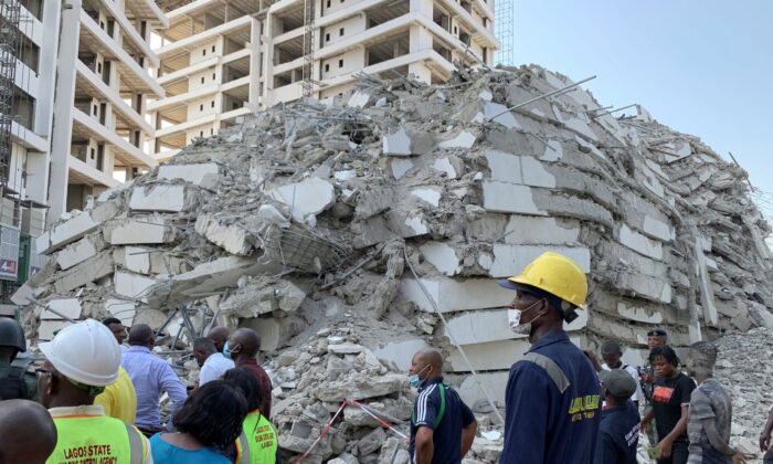 Emergency personnel stands by the debris of the collapsed building in Ikoyi, Lagos, Nigeria on Nov. 1, 2021. (Nneka Chile/Reuters)