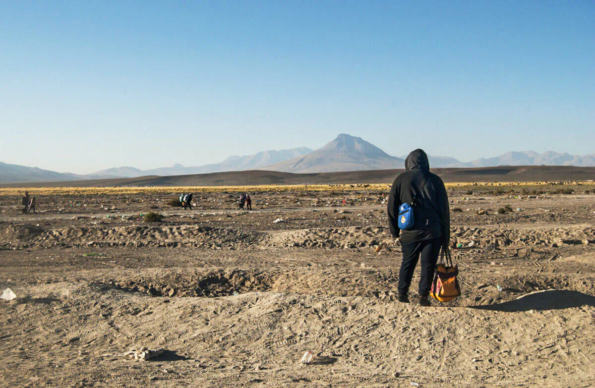 A migrant looks across the border into Chile on Oct. 26, 2021. (Cesar Calani Cosso/Epoch Times)