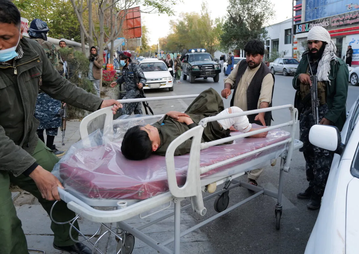 A boy, injured during a blast, lies on a stretcher at the entrance of a hospital in Kabul, Afghanistan, on Nov. 2, 2021. (Zohra Bensemra/Reuters)