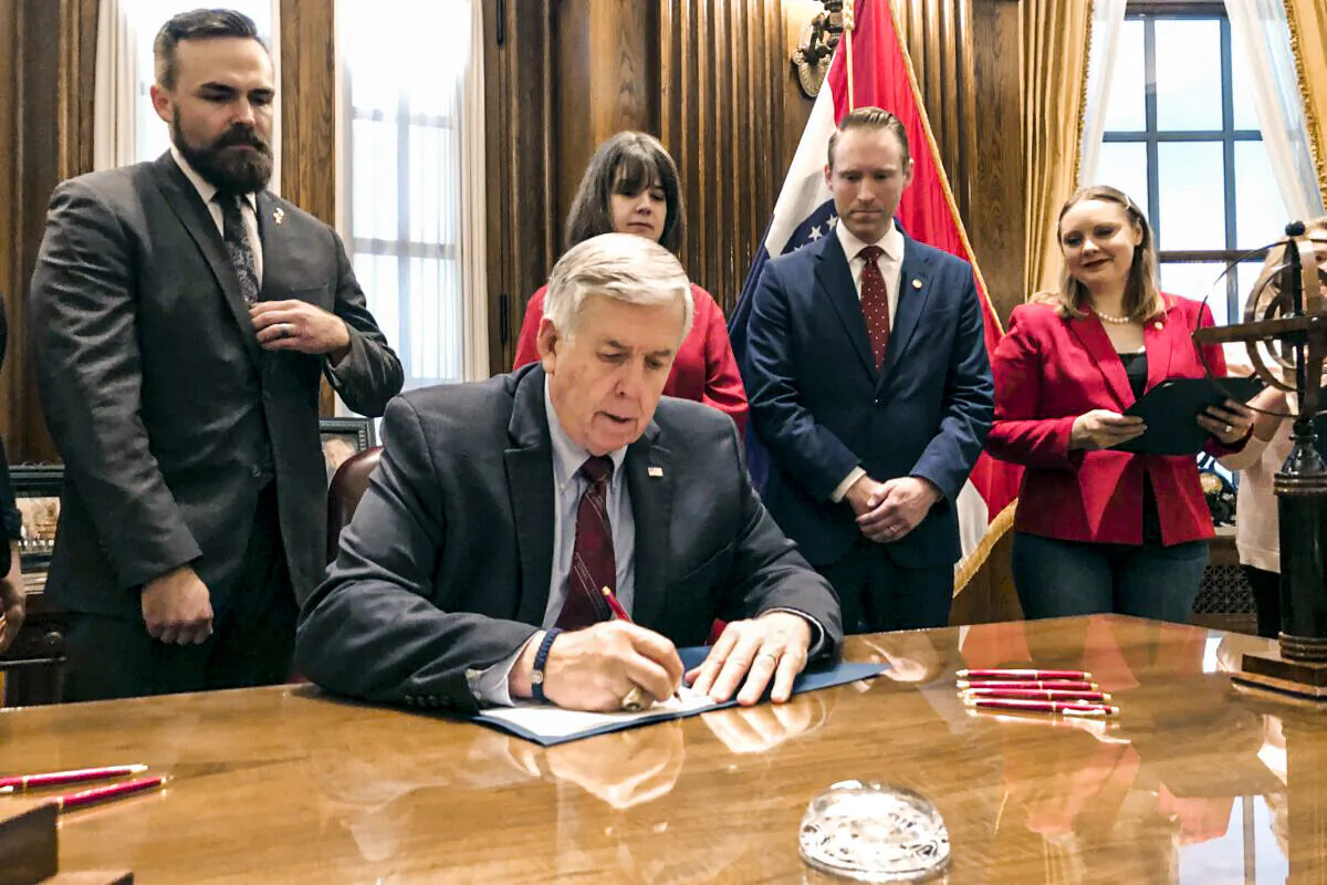 FILE- In a May 24, 2019, file photo, Missouri Gov. Mike Parson signs one of the nation's most restrictive abortion bills, banning the procedure on or beyond eight weeks of pregnancy, in Jefferson City, Mo. A federal appeals court panel on Wednesday, June 9, 2021, blocked Missouri from enforcing the sweeping state abortion law. A three-judge panel of the 8th U.S. Circuit Court of Appeals in St. Louis heard arguments in September in the legal battle over the 2019 law. (AP Photo/Summer Balentine, File)