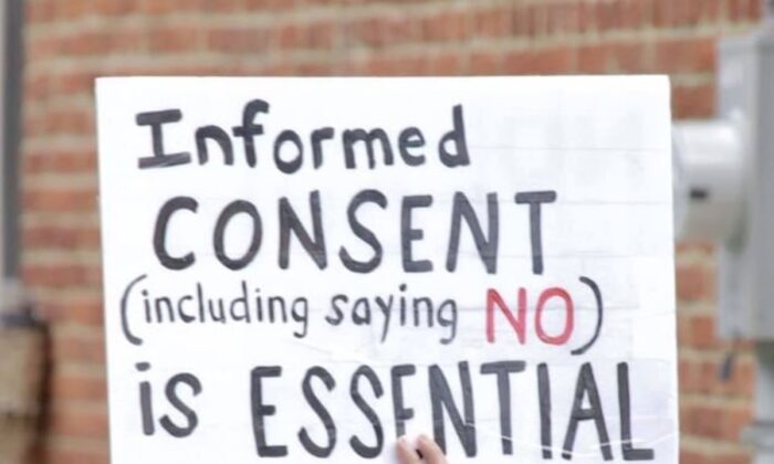 A protester holds a sign at a Pennsylvania rally in support of Penn Medicine workers. (Courtesy of   Pennsylvania Informed Consent Advocates Inc.)