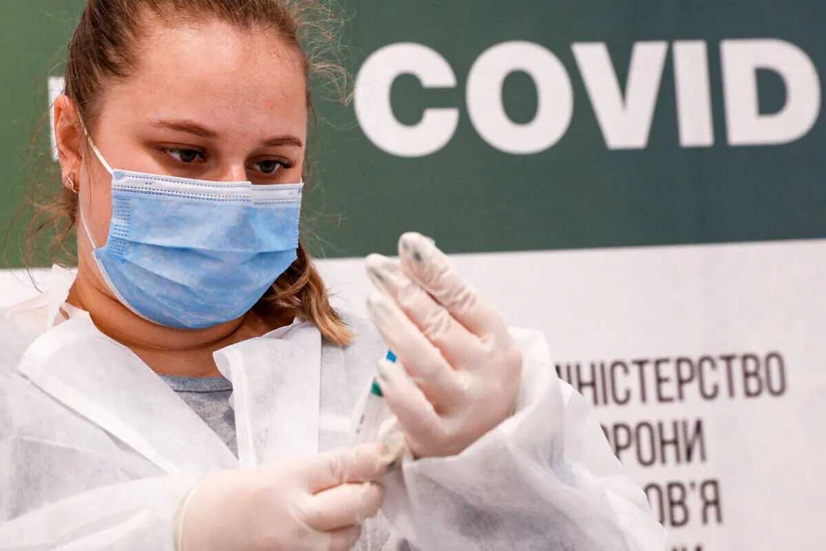 A medical worker fills a syringe with the Pfizer-BioNTech vaccine against the coronavirus disease (COVID-19) at a vaccination centre in Kyiv, Ukraine, on Oct. 27, 2021. (Valentyn Ogirenko/Reuters)