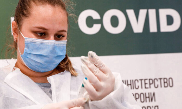 A medical worker fills a syringe with the Pfizer-BioNTech vaccine against the coronavirus disease (COVID-19) at a vaccination centre in Kyiv, Ukraine, on Oct. 27, 2021. (Valentyn Ogirenko/Reuters)