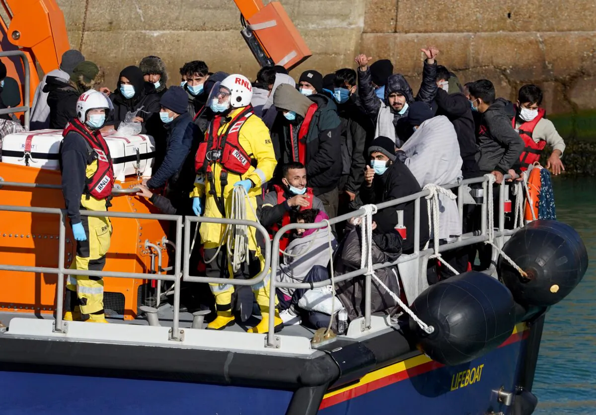 A group of people thought to be migrants are brought into Dover, England. (PA)