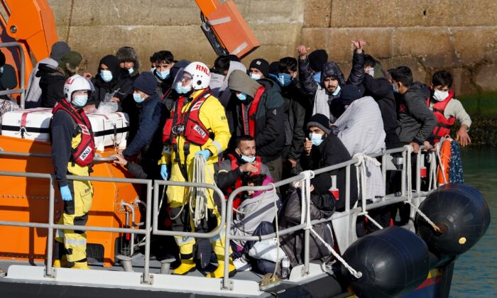 A group of people thought to be migrants are brought into Dover, England. (PA)