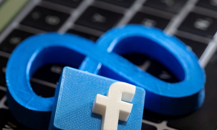 Taken on November 2, 2021, this figure shows the new 3D-printed Facebook rebranding logo Meta and Facebook logo placed on a laptop keyboard.  (DadoRuvic / Reuters)