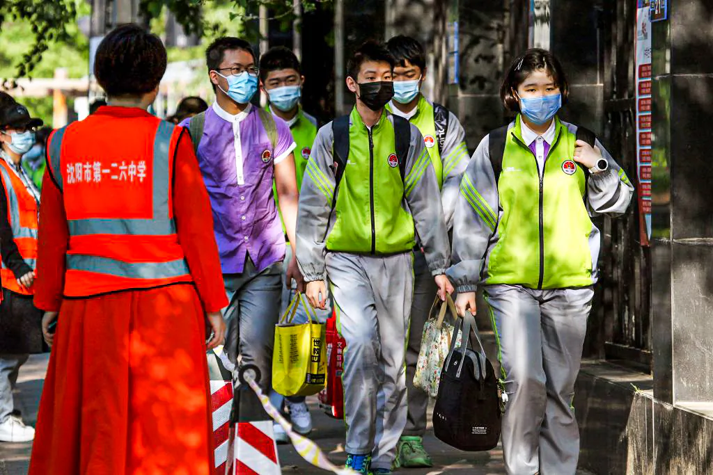 Students wearing face masks queue to enter a middle school in Shenyang, in northeastern China's Liaoning province on May 29, 2020. (STR/AFP via Getty Images)
