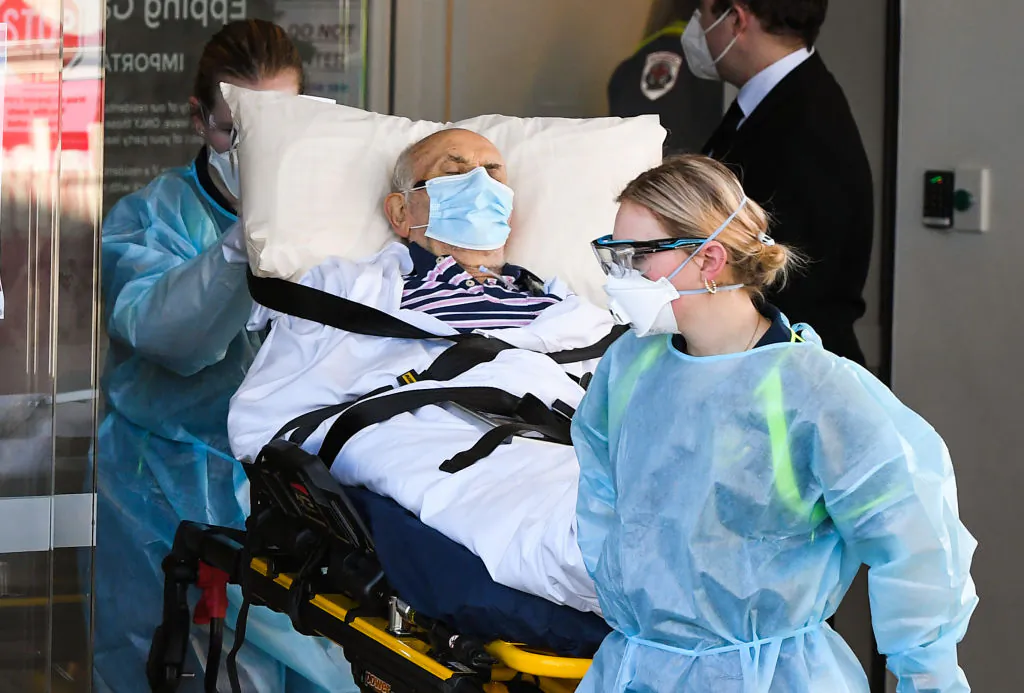 Ambulance officers transport a resident from the Epping Gardens aged care facility in the Melbourne suburb of Epping in Australia, on Jul. 29, 2020, (William West/AFP via Getty Images)