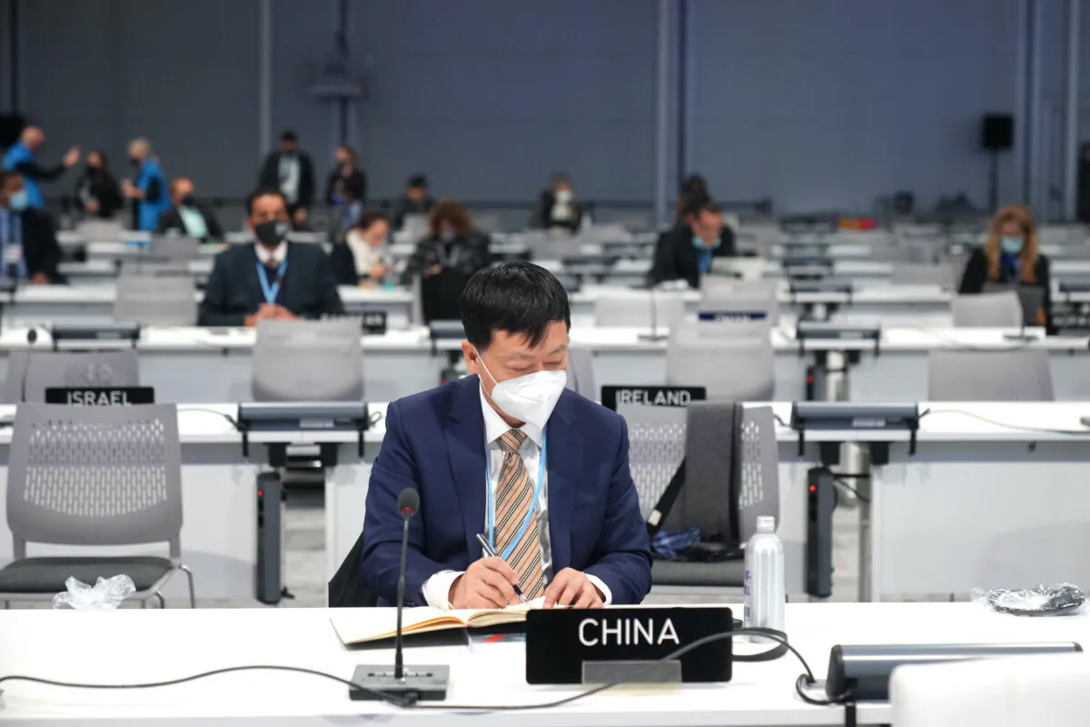 A delegate for China prepares ahead of the start of COP26 at the Scottish Event Campus in Glasgow, Scotland, on Oct. 31, 2021. (Christopher Furlong/Getty Images)