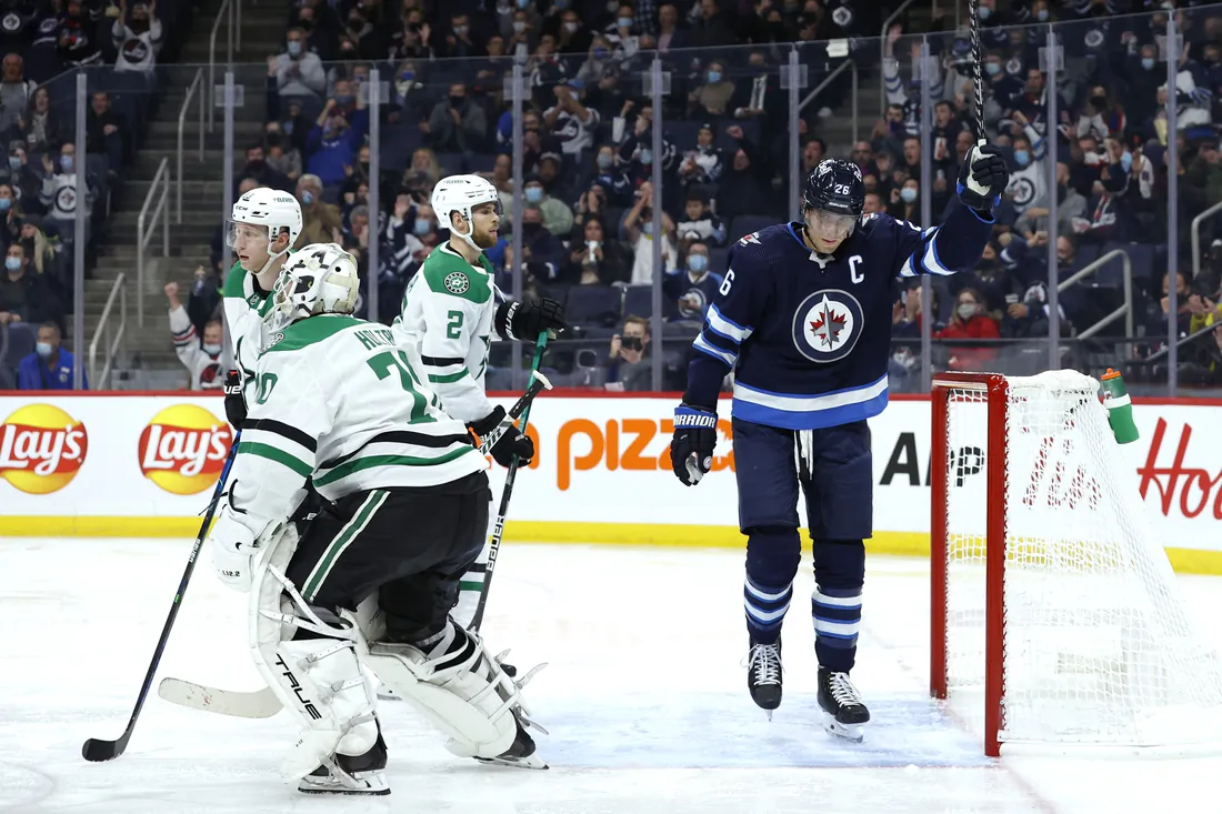 Winnipeg Jets right wing Blake Wheeler (26) celebrates the second period goal by Winnipeg Jets defenseman Josh Morrissey (44) on
 Dallas Stars goaltender Braden Holtby (70) at Canada Life Centre, on Nov. 2, 2021.
 (James Carey Lauder/USA TODAY Sports via Field Level Media)
