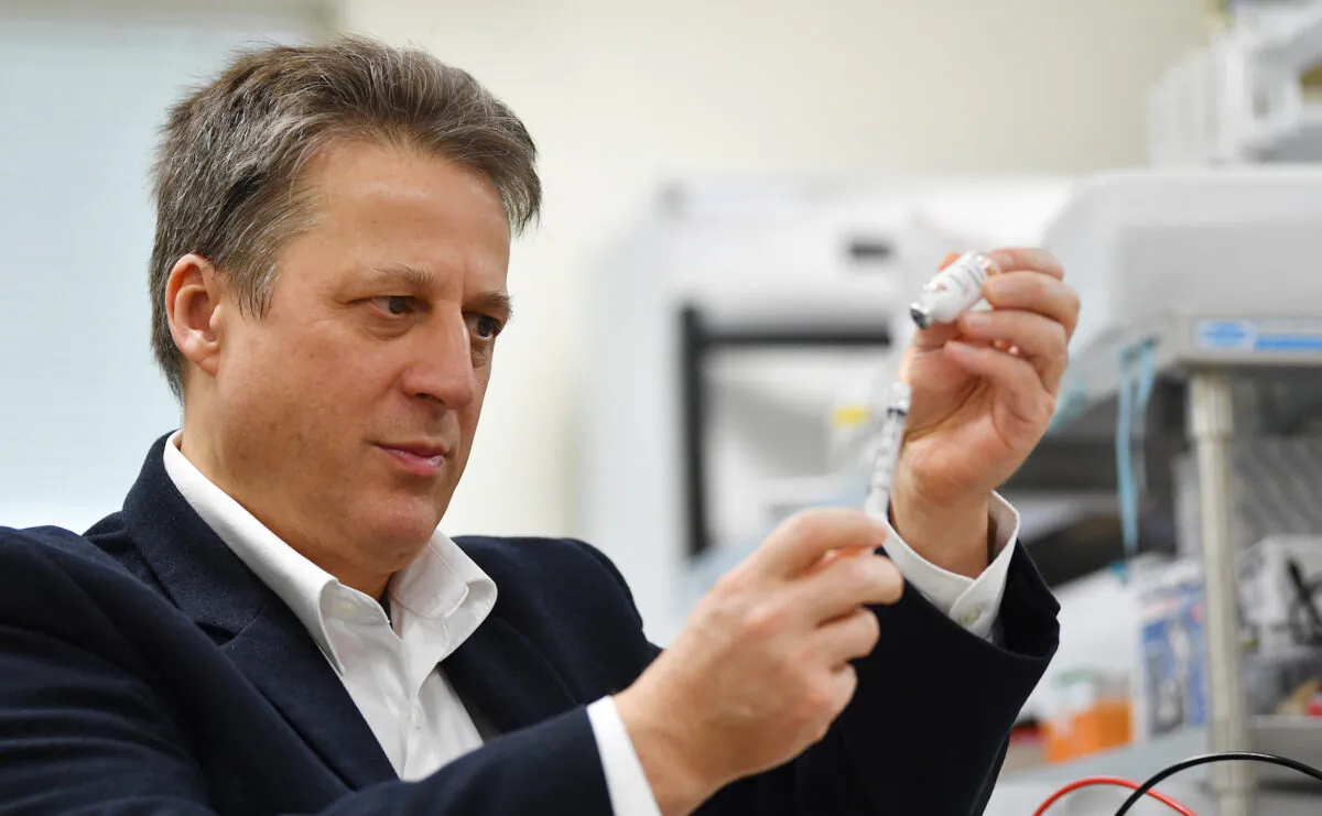 Vaxine research director Nikolai Petrovsky in the Flinders University lab in Adelaide, South Australia, with a vaccine specimen on July 2, 2020. (AAP Image/David Mariuz)