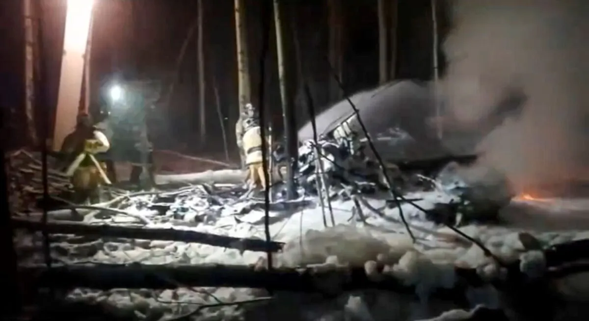 In this image from video provided by the Russian Emergency Ministry Press Service, Russian rescuers work at the side of an An-12 cargo plane crash in Irkutsk, eastern Siberia, on Nov. 3, 2021. (Russian Emergency Ministry Press Service via AP)