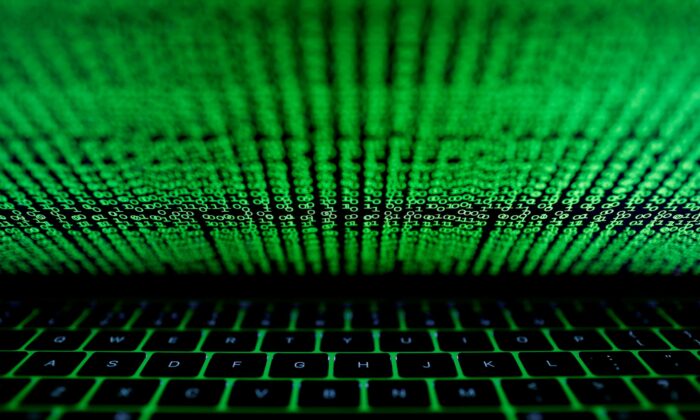 A computer keyboard lit by a displayed cyber code is seen in this illustration picture taken on March 1, 2017. (Kacper Pempel/Reuters)