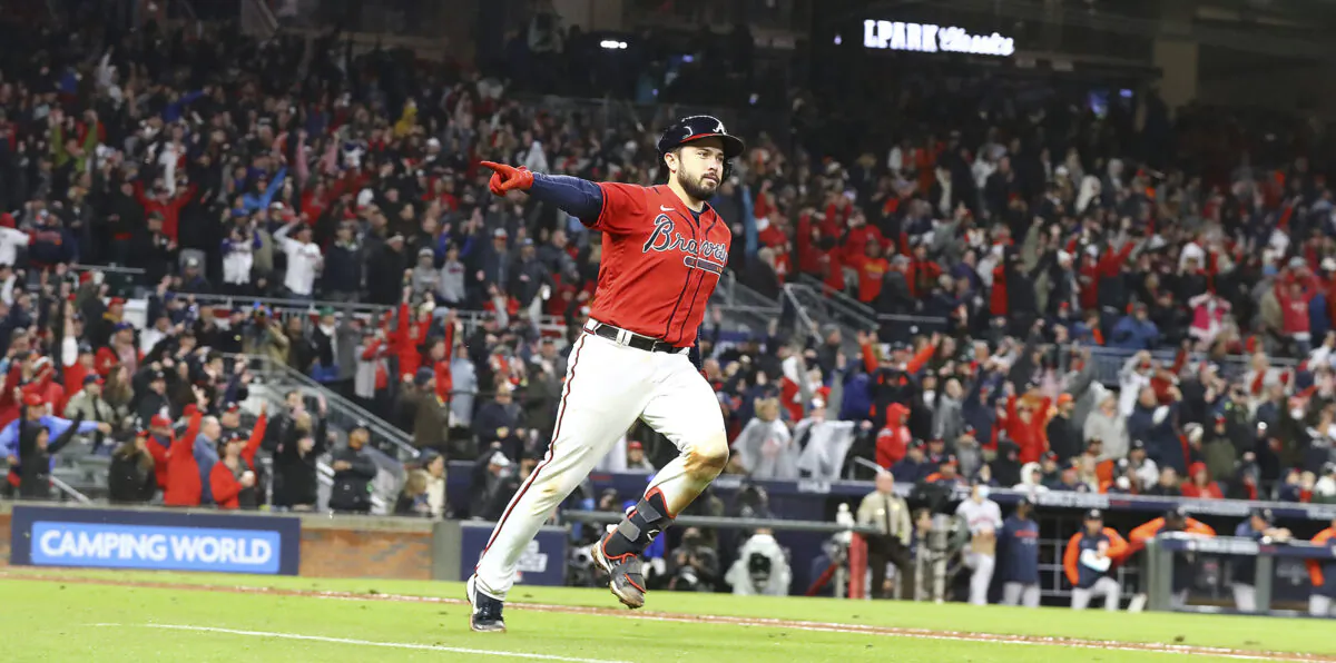 Atlanta Braves' Travis d'Arnaud points at the dugout while rounding the bases on his solo home run in the eighth inning against the Houston Astros in Game 3 of the baseball World Series in Atlanta, on Oct. 29, 2021 (Curtis Compton/Atlanta Journal-Constitution via AP)