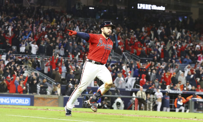 Atlanta Braves' Travis d'Arnaud points at the dugout while rounding the bases on his solo home run in the eighth inning against the Houston Astros in Game 3 of the baseball World Series in Atlanta, on Oct. 29, 2021 (Curtis Compton/Atlanta Journal-Constitution via AP)