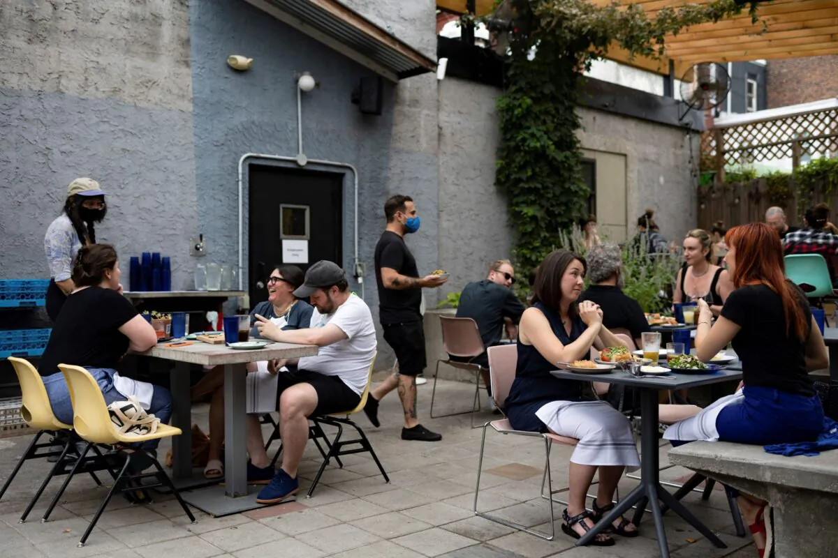 Customers drink and dine outdoors at the restaurant "Martha" in Philadelphia, Pa., on Aug. 7, 2021. (Hannah Beier/Reuters)