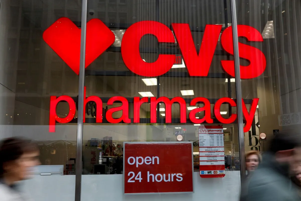 People walk by a CVS Pharmacy store in the Manhattan borough of New York City, N.Y., on Nov. 30, 2017. (Shannon Stapleton/Reuters)