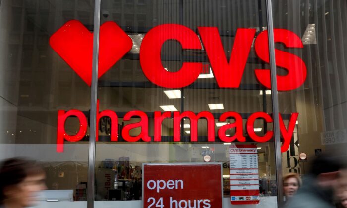 People walk by a CVS Pharmacy store in the Manhattan borough of New York on Nov. 30, 2017. (Shannon Stapleton/Reuters)
