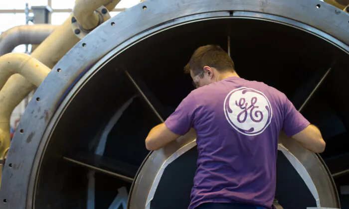 An employee of U.S. multinational General Electric (GE) works on a gas turbine at the GE plant in Belfort, eastern France, on Oct. 27, 2015. (Sebastien Bozon/Getty Images)