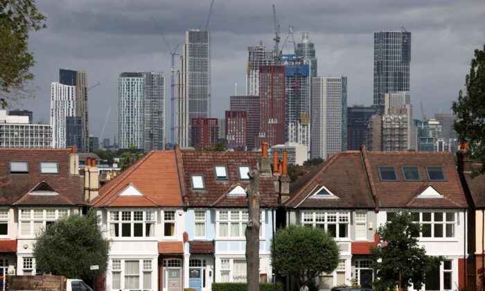 The high-rise condominium under construction can be seen in the distance behind a row of houses in southern London, England, on August 6, 2021.  (HenryNicholls / Reuters)