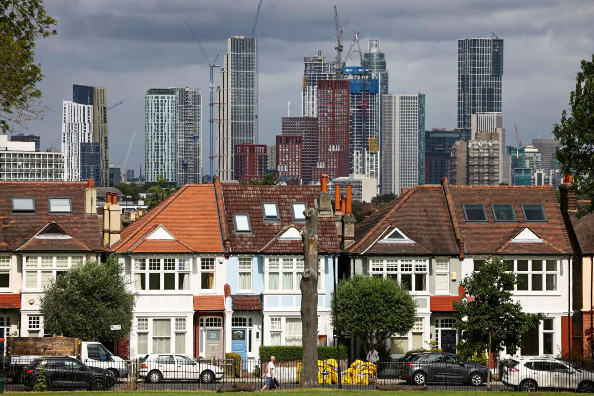High-rise apartments under construction can be seen in the distance behind a row of residential housing in south London, Britain, on Aug. 6, 2021. (Henry Nicholls/Reuters)