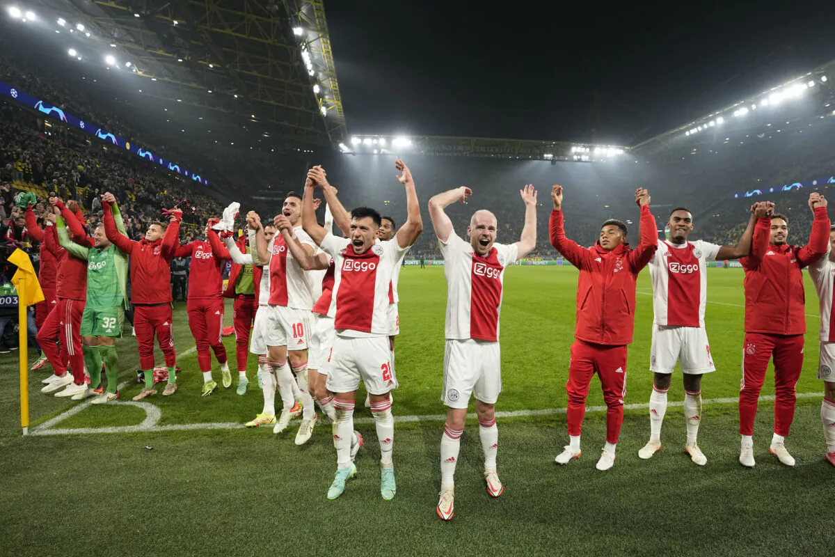 Ajax players celebrate at the end of the Champions League group C soccer match between Borussia Dortmund and Ajax Amsterdam in Dortmund, Germany, on Nov. 3, 2021. Ajax won 3:1. (Martin Meissner/AP Photo)