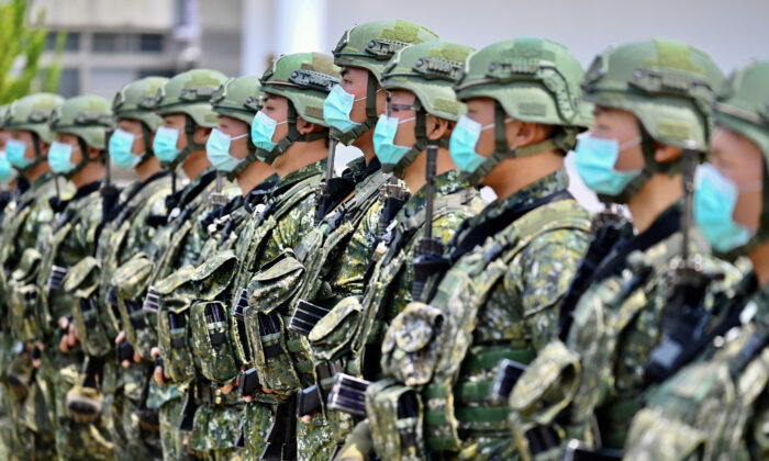 Soldiers wearing face masks amid the COVID-19 coronavirus pandemic listen to an address by Taiwan President Tsai Ing-wen during her visit to a military base in Tainan, southern Taiwan, on April 9, 2020. (Sam Yeh/AFP/Getty Images/TNS)