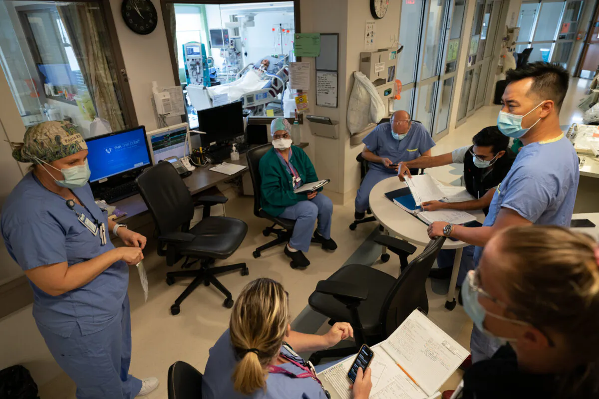 Nurses and doctors hold a morning briefing about a patient at the COVID-19  Intensive Care Unit at Surrey Memorial Hospital in Surrey, B.C., on June 4, 2021. (The Canadian Press/Jonathan Hayward)