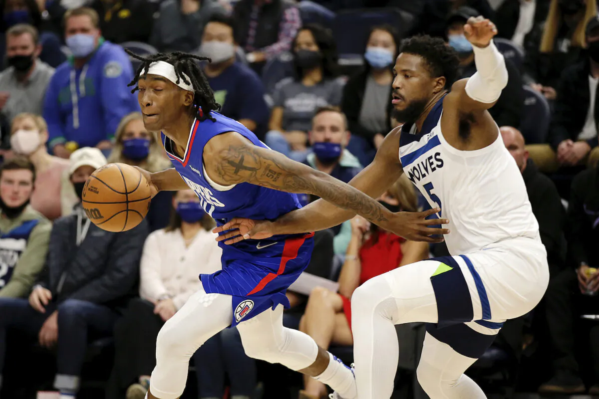 Los Angeles Clippers guard Terance Mann (14) drives on Minnesota Timberwolves guard Malik Beasley (5) during the first half of an NBA basketball game in Minneapolis on Nov. 3, 2021. (AP Photo/Andy Clayton-King)