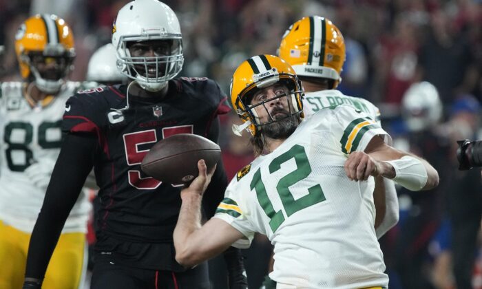 Green Bay Packers quarterback Aaron Rodgers throws the ball into the crowd, as time expires during the second half of an NFL football game against the Arizona Cardinals, in Glendale, Ariz., on Oct. 28, 2021. (Rick Scuteri/AP Photo)
