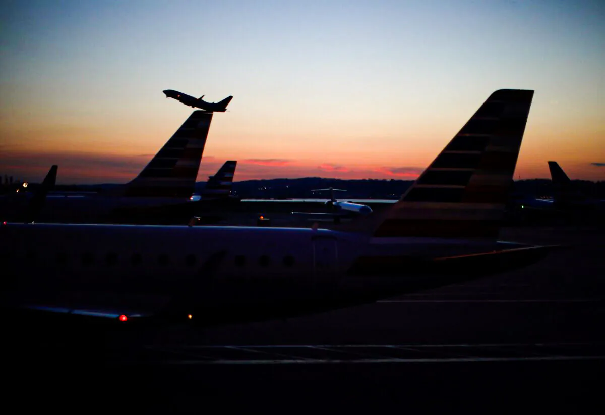 An airplane takes off from the Ronald Reagan National Airport in Washington, on March 18, 2020. (Carlos Barria/Reuters)
