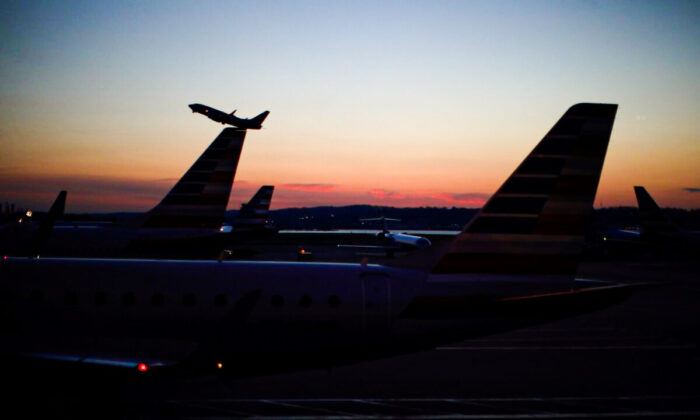 An airplane takes off from the Ronald Reagan National Airport in Washington, on March 18, 2020. (Carlos Barria/Reuters)