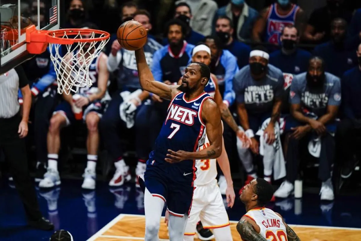Brooklyn Nets' Kevin Durant (7) drives past Atlanta Hawks' John Collins (20) during the first half of an
 NBA basketball game in New York, on Nov. 3, 2021. (Frank Franklin II/AP Photo)