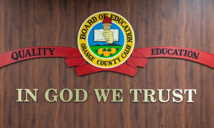 "IN GOD WE TRUST" hangs in the meeting area of the Orange County Board of Education in Costa Mesa, Calif., on Oct. 7, 2020. (John Fredricks/The Epoch Times)