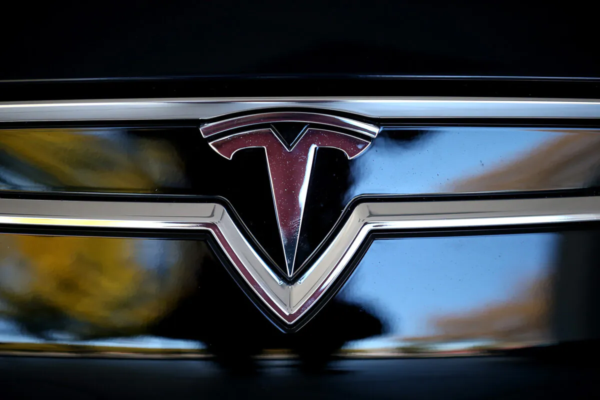 The Tesla logo is shown on the front of a new Tesla Model S car at a Tesla showroom in Palo Alto, Calif., on Nov. 5, 2013. (Justin Sullivan/Getty Images)