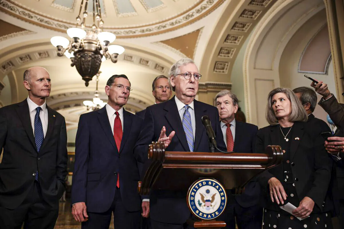 Senate Minority Leader Mitch McConnell (R-Ky.) addresses reporters following a weekly Republican policy luncheon as (L-R) Sen. Rick Scott (R-Fla.), Sen. John Barrasso (R-Wyo.), Sen. John Thune (R-S.D.), Sen. Roy Blunt (R-Mo.), and Sen. Joni Ernst (R-Iowa) look on in the U.S. Capitol in Washington on Oct. 5, 2021. (Anna Moneymaker/Getty Images)