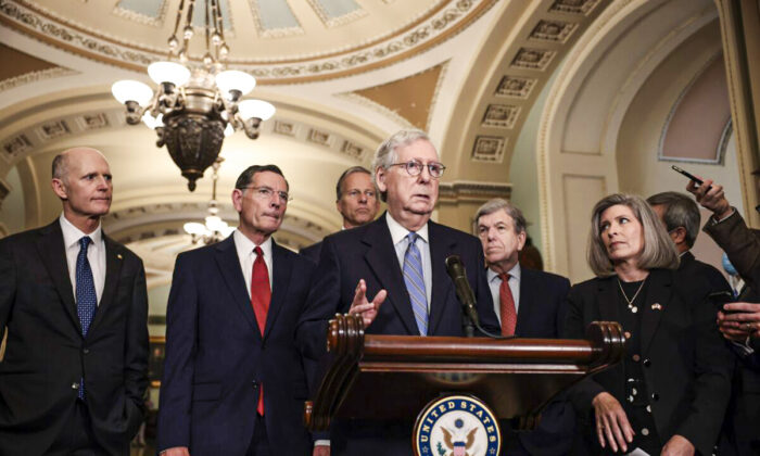 WASHINGTON, DC - OCTOBER 05: Senate Minority Leader Mitch McConnell (R-KY) addresses reporters following a weekly Republican policy luncheon as (L-R) Sen. Rick Scott (R-FL), Sen. John Barrasso (R-WY), Sen. John Thune (R-SD), Sen. Roy Blunt (R-MO), and Sen. Joni Ernst (R-IA) look on in the U.S. Capitol on October 05, 2021 in Washington, DC. During their news conference McConnell reiterated his belief that the Senate should pass legislation to raise the federal debt-limit through reconciliation. (Photo by Anna Moneymaker/Getty Images)
