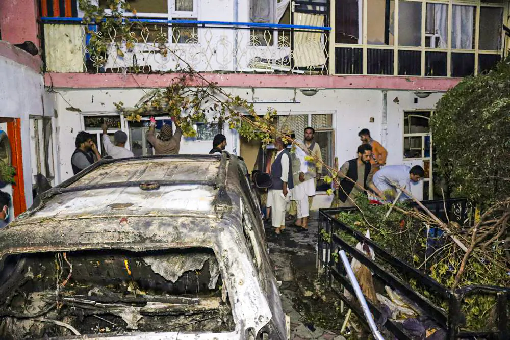 FILE - Afghans inspect damage of Ahmadi family house after U.S. drone strike on Aug. 29, 2021, in Kabul, Afghanistan. An independent Pentagon review has concluded that the U.S. drone strike that killed innocent Kabul civilians and children in the final days of the Afghanistan war was not caused by misconduct or negligence, and it doesn't recommend any disciplinary action, The Associated Press has learned. (AP Photo/Khwaja Tawfiq Sediqi, File)