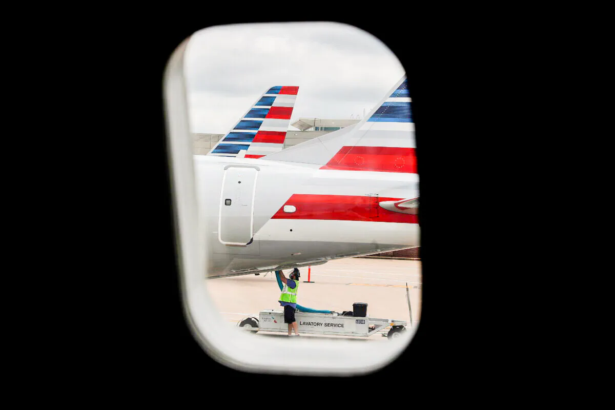 An airlines worker works on an American Airlines plane that arrived at Hartsfield–Jackson Atlanta International Airport in Atlanta, Ga. on May 19, 2020. (Shannon Stapleton/Reuters)