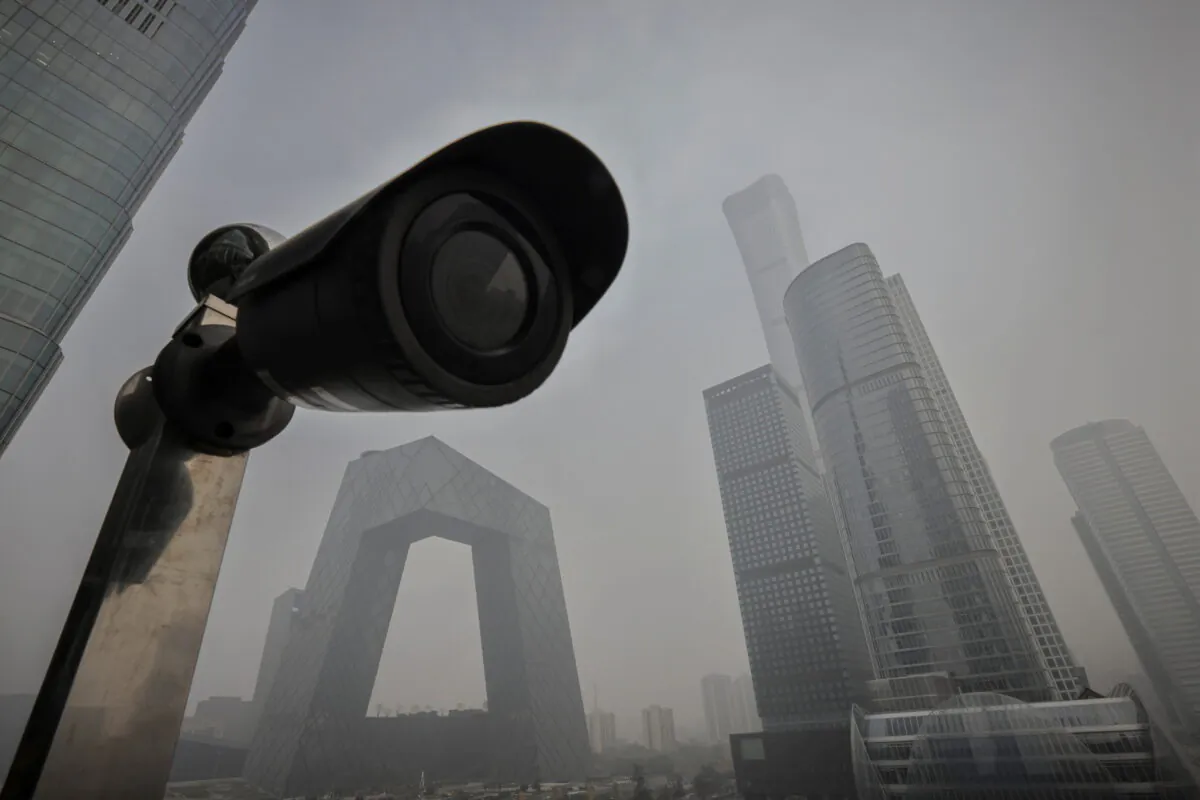 A surveillance camera points at a terrace of a shopping mall overlooking the skyline of the Central Business District on a polluted day in Beijing, China, on Nov. 5, 2021. (Thomas Peter/Reuters)