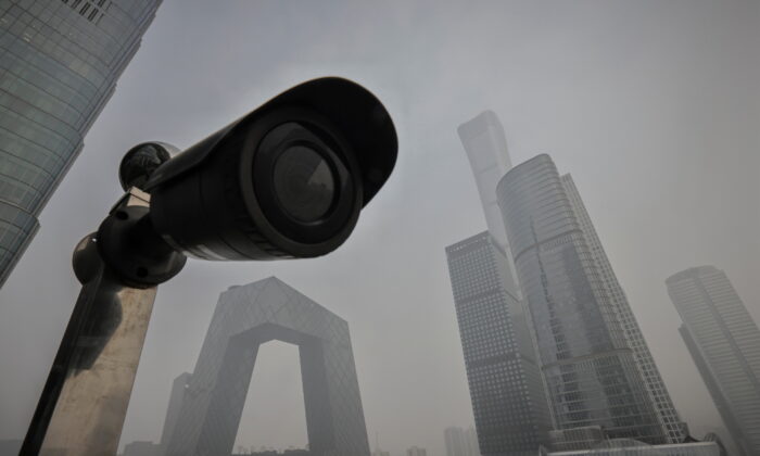 A surveillance camera points at a terrace of a shopping mall overlooking the skyline of the Central Business District on a polluted day in Beijing, China, on Nov. 5, 2021. (Thomas Peter/Reuters)