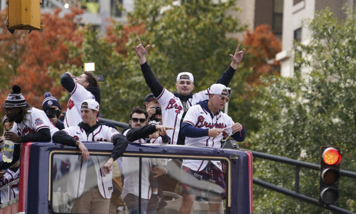 Atlanta Braves players celebrate the team’s victory during a victory parade, in Atlanta, on Nov. 5, 2021. (Brynn Anderson/AP Photo)